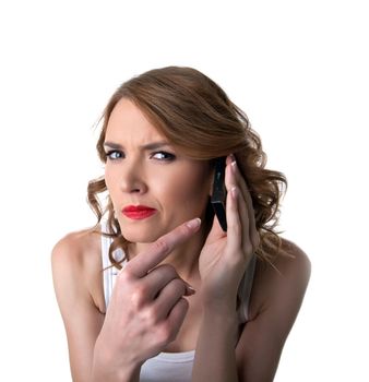 Young woman point on cell phone with suspicious emotion isolated