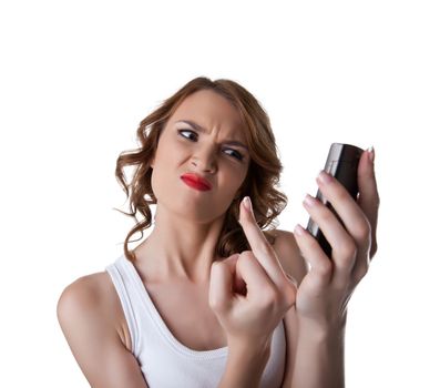 Anger Young woman show fuck finger on cell phone isolated