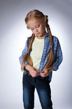 Studio portrait of pretty blonde Thoughtful girl
