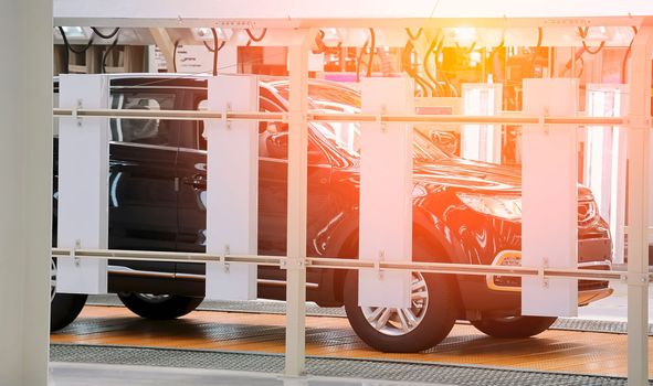 Photo of automobile production line. Modern car assembly plant. Modern and high-tech automotive industry. Conveyor of auto bodies