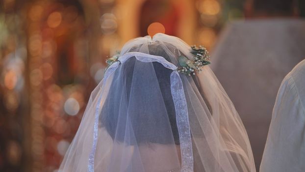 Veil and wreath close-up on the bride during the wedding