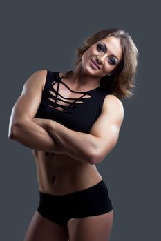 Athletic beauty woman bodybuilder in fashion cloth portrait