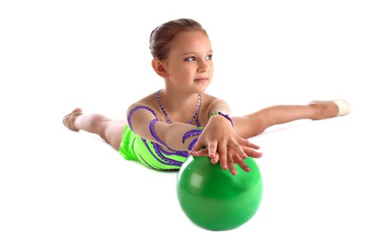 Kid lay with green gymnastic ball isolated