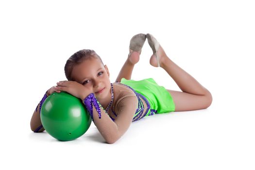 Kid lay with green gymnastic ball isolated