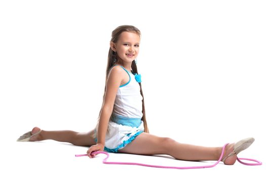Young kid gymnast doing split with skipping rope isolated