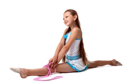 Young kid gymnast posing with skipping rope isolated