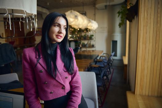 Portrait of confident Caucasian middle-aged businesswoman in elegant suit in modern restaurant interior. Business, finance and employment, female successful entrepreneurs concept. Restaurant business