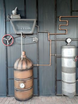 Vintage brewing equipment on a gray wall close-up
