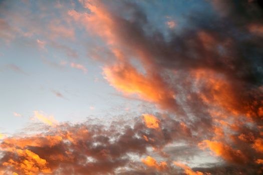 sunset sky with dark orange clouds for background close up