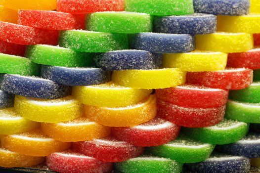 bright multicolored slices of marmalade laid out in an even pile for a food background