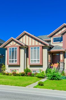 A perfect neighborhood. Main entrance of big family house with concrete door steps in front. Residential house with the entrance under the porch