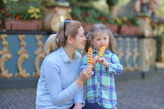 Mother and daughter enjoy ice cream in a park Efteling, Holland