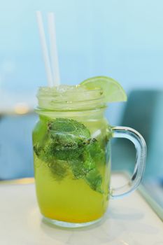 Mojito with lime and mint in a glass mug
