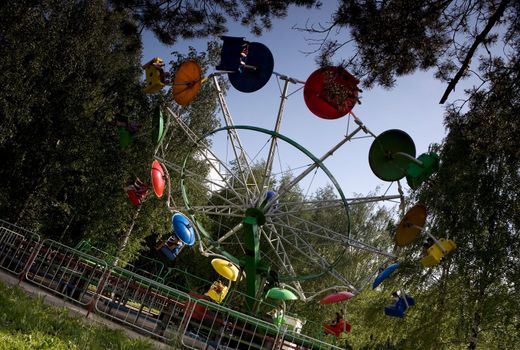 Carousel rotation in park amusement sunny day