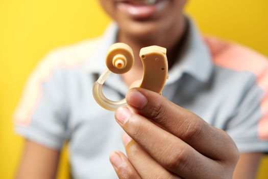 Hearing aid concept, teenage boy with hearing problems.,