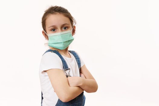 Adorable little girl in protective mask, isolated on white. Virus symptoms. Concept of air pollution, epidemic, influenza, protection from disease. Flu illness. Pediatrics. Medical care. Insurance.