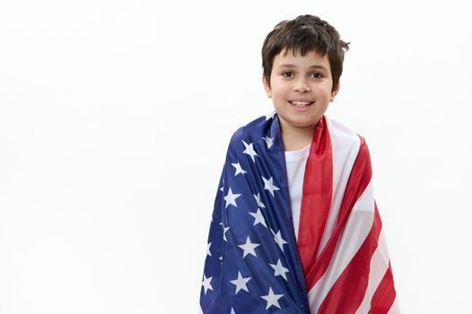 Isolated portrait on white background of a happy American teenage boy with USA flag. Citizenship, immigration, emigration, winning the green card lottery and freedom concept. Independence Day July 4