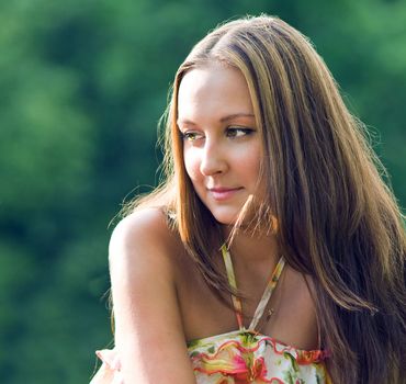 Young beautiful woman in nature background