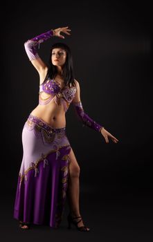 Woman dance in traditional purple arabian costume