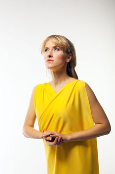 Blond woman in yellow veil play role