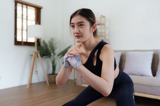 Healthy asian woman practicing relaxation yoga at home. Spending time and playing at home concept.