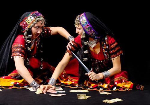 two indian woman fight for money with knife