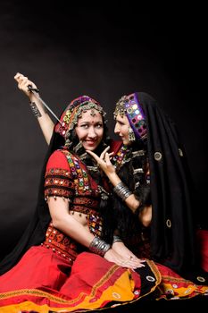 two young woman play with knife - indian costume
