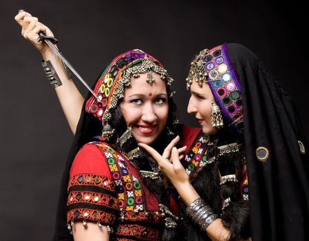 two young woman play with knife - indian costume