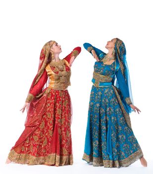 Two young beauty women dance in indian costume