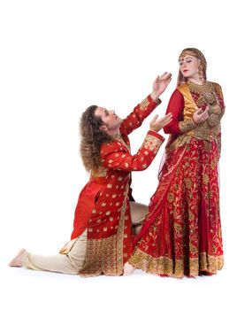 young man pleads with Indian girl - traditional costume