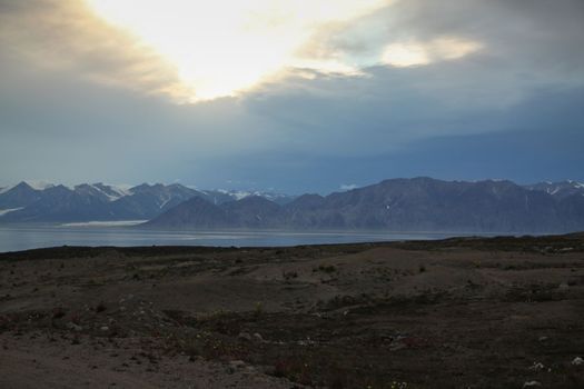 View of mountains across the bay from the community of Pond Inlet in the Baffin Region of the territory of Nunavut, Canada