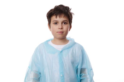 Isolated portrait on white background of handsome Caucasian schoolboy wearing lab coat, confidently looking at camera, isolated on white background with advertising space for your promotional text