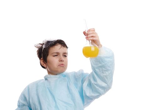 Caucasian smart nerd schoolboy, chemist scientist in lab coat, holds glass laboratory flasks with chemicals, watches the reaction taking place between liquid and reagents, isolated on white background