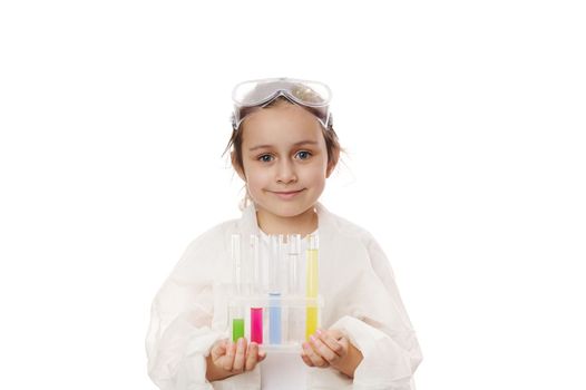 Caucasian smart child girl learning science chemistry, holding test tubes making experiment at school laboratory. Education Science Chemistry and children concept . Early development of children.