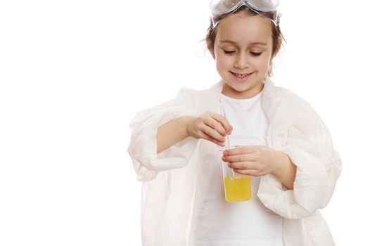 Details: child's hands mixing yellow liquid chemical solution in a measuring laboratory beaker, with glass stick at chemistry class, isolated on white background with copy space for your advertising