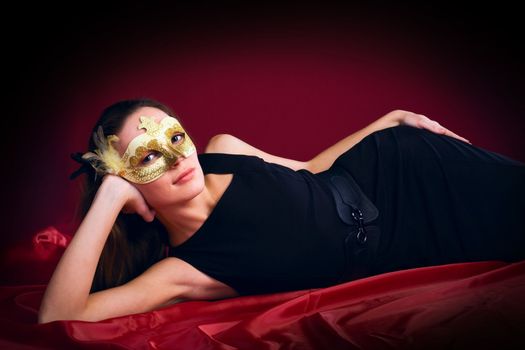 beauty woman in mask on red background