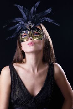 woman in mask with feather kiss you
