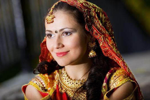 young pretty woman in indian dress look forward