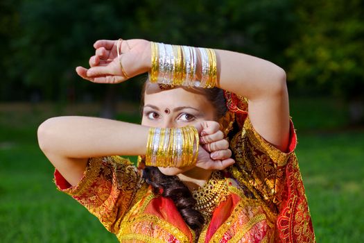 A young Indian woman hiding face with hands