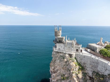 Aerial view of Swallow's Nest castle on the rock in Black Sea. It is a symbol and landmark of Crimea. Beautiful scenic panorama of the Crimea coast. Amazing Swallow's Nest at the precipice.