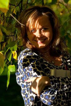 Beauty woman with book in autumn tree at sunset