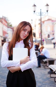 Young beauty student with notebook in old town