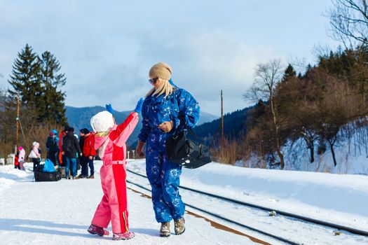 daughter and mother on the platform of winter.