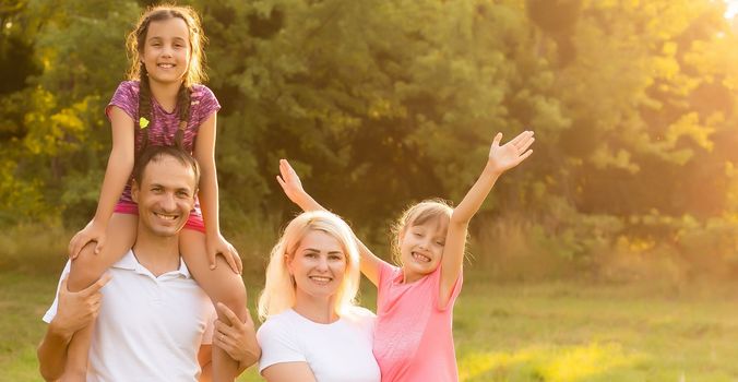 Happy family enjoying life together at meadow outdoor