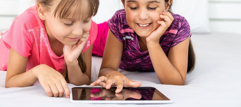 Little girls using tablet computer as art board - painting together.