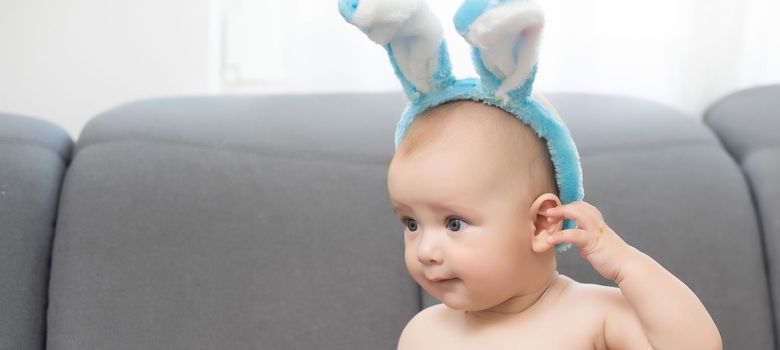 Portrait of a cute baby dressed in Easter bunny ears.