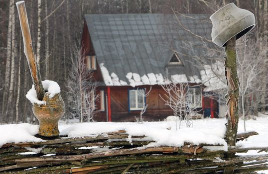 wooden house in winter forest