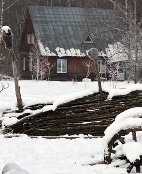 wooden house in winter forest