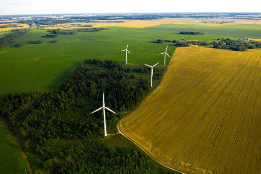 Windmills on the background of forests and fields. Windmill in nature.Belarus.