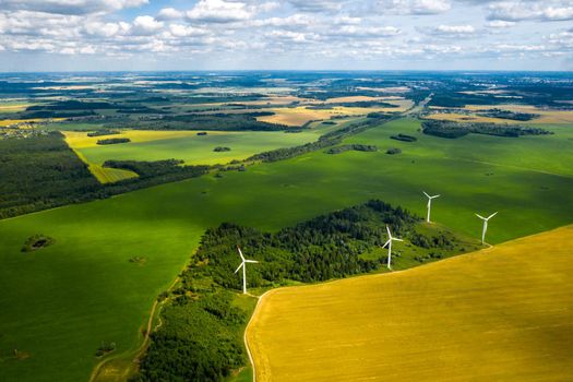 Windmills on the background of forests and fields. Windmill in nature.Belarus.